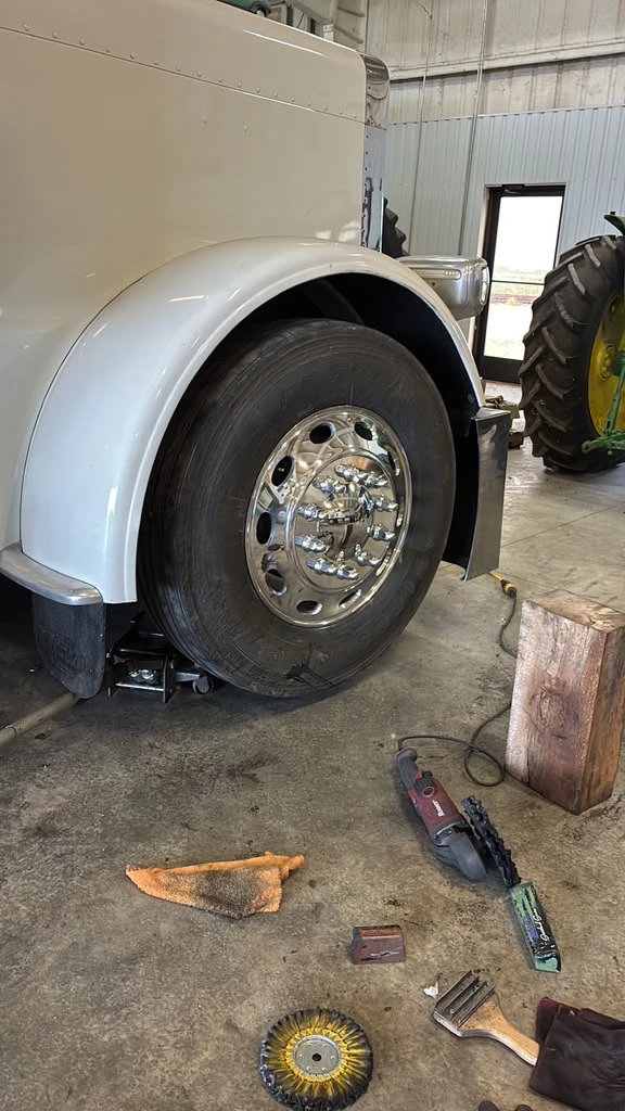 Semi truck wheel before polishing with polishing tools laid out