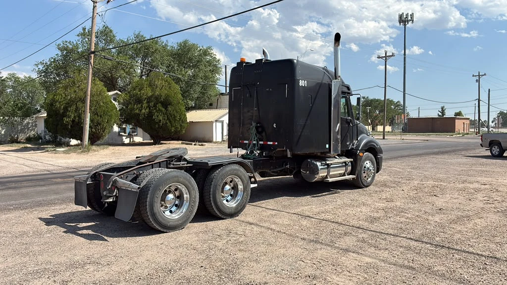 Black semi truck day cab with polished aluminum wheels